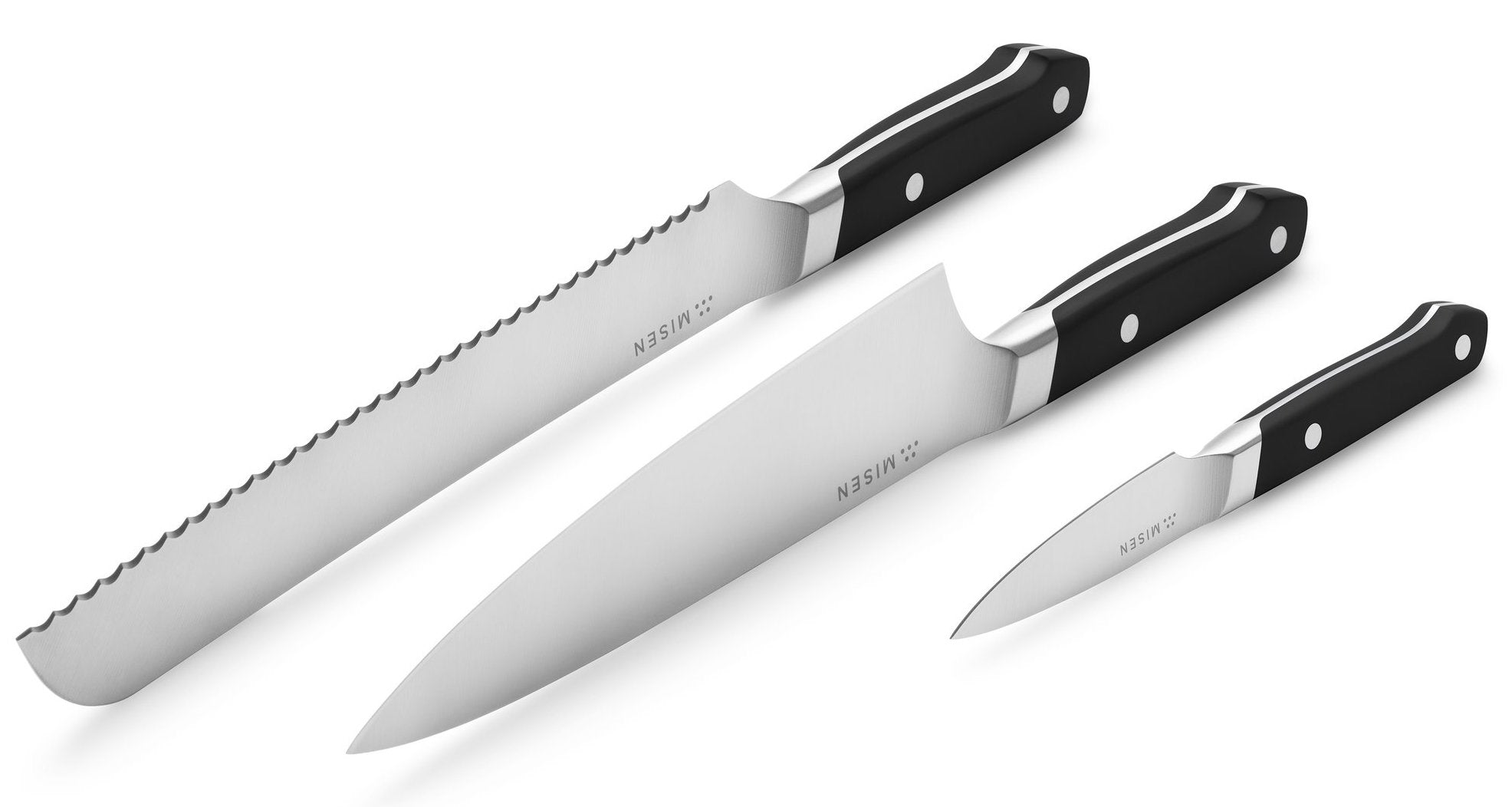 Parts of a knife: a serrated, chef's, and pairing knife with the blades facing up