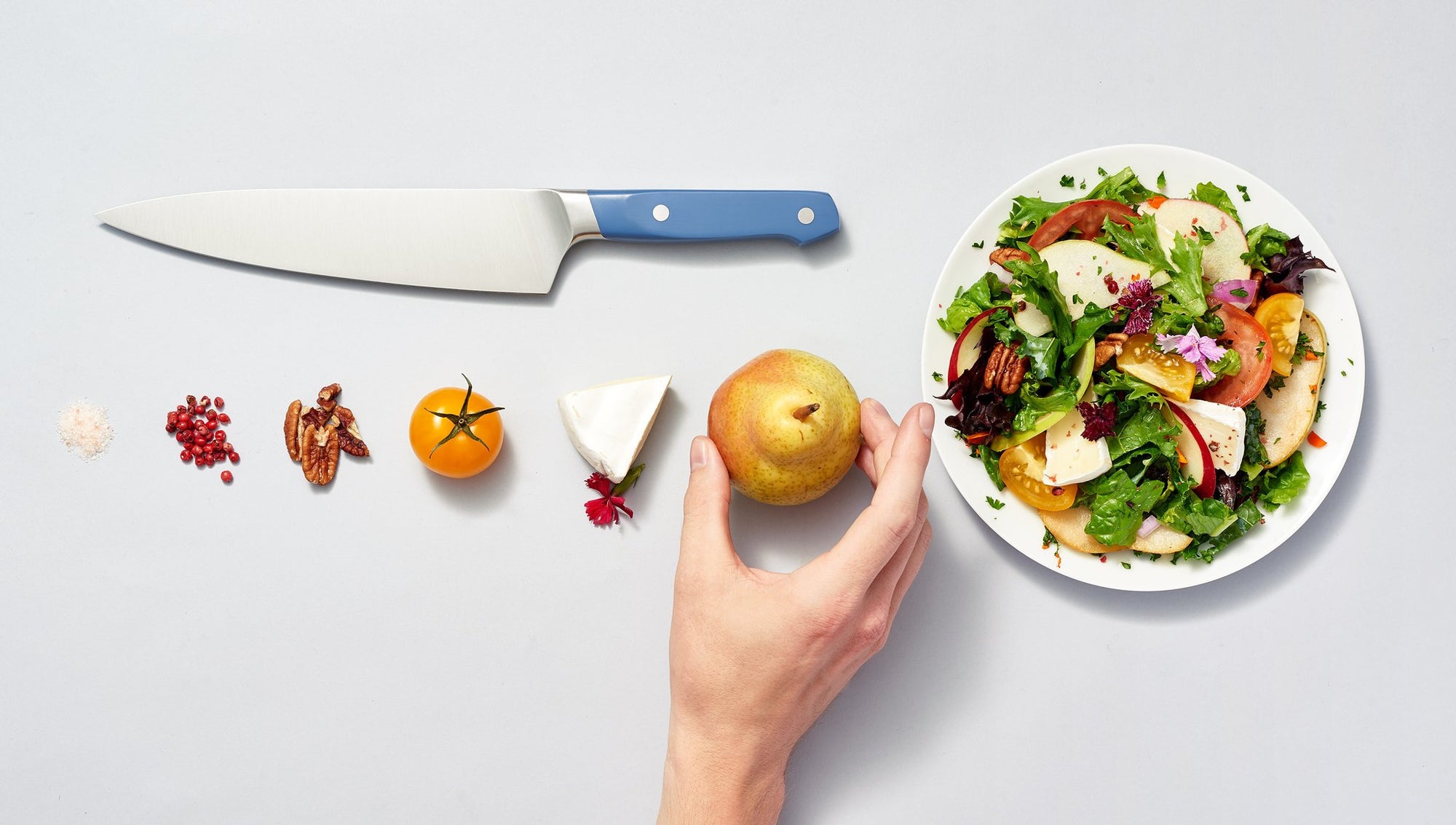A Misen Chef's Knife with ingredients and a salad