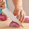 Cutting a red onion with a Misen 8 inch Chef Knife.