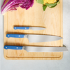 The Misen three piece Knife Set in blue comes with a paring knife an eight inch chef's knife and an eight inch serrated knife.