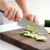 Slicing a cucumber with a blue Misen Santoku Knife