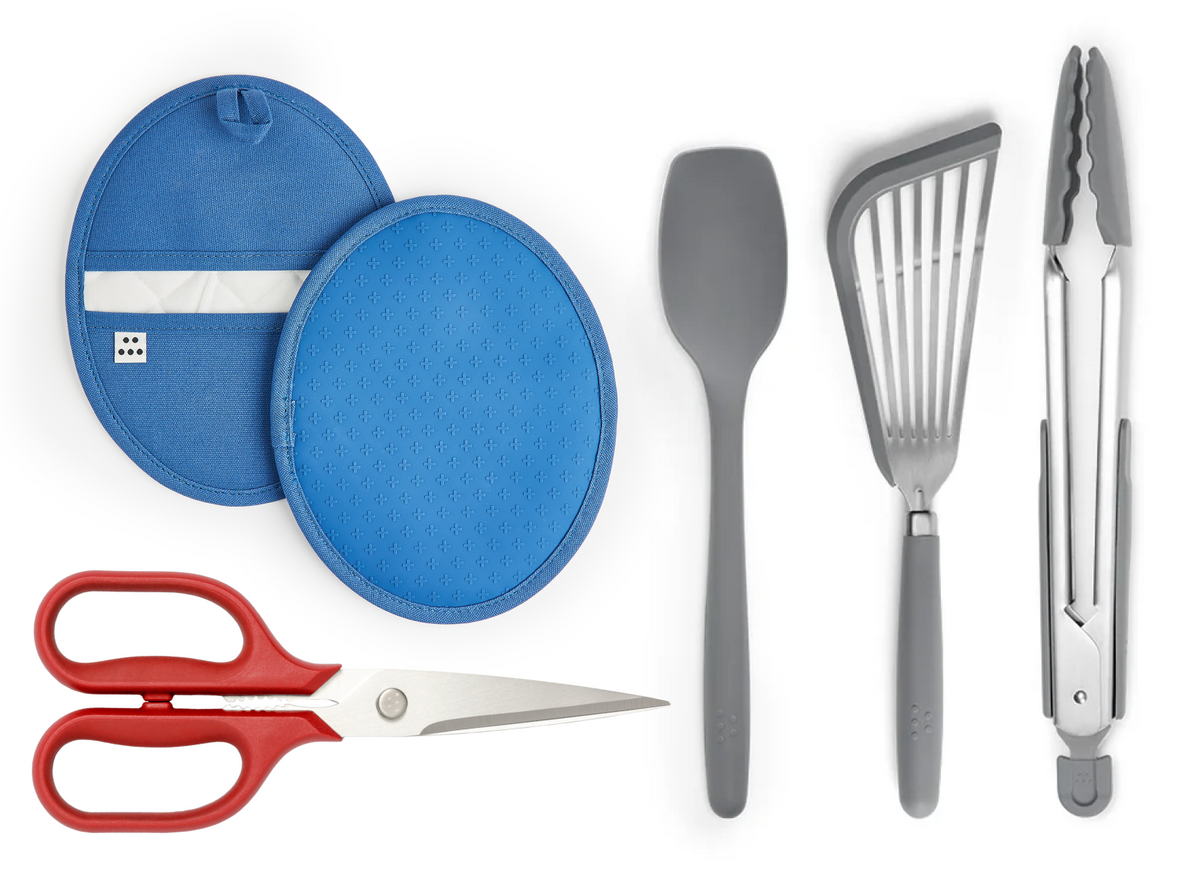 The Prep Starter Kit contains a pair of blue Pot Holders, a pair of red Kitchen Shears, a gray Spoontula, a Gray Silicone Fish Spatula and a pair of large, gray Silicone Tongs