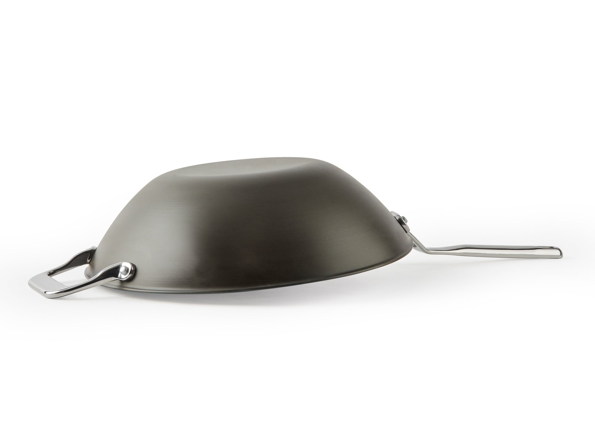 {{12-inch}} A side view of the Misen Carbon Steel Wok resting upside down on a white background. The wok’s flat base is clearly visible.