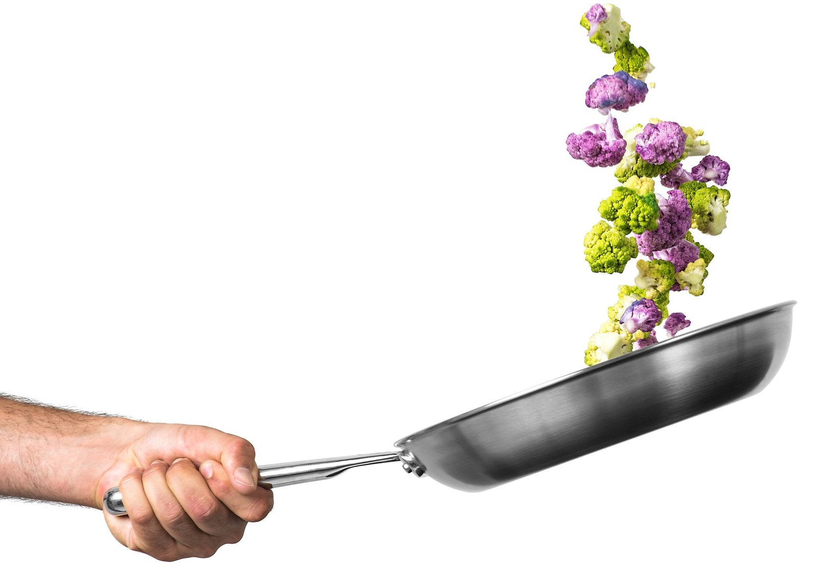 Best stainless steel cookware: A hand flips cauliflower in a stainless steel skillet