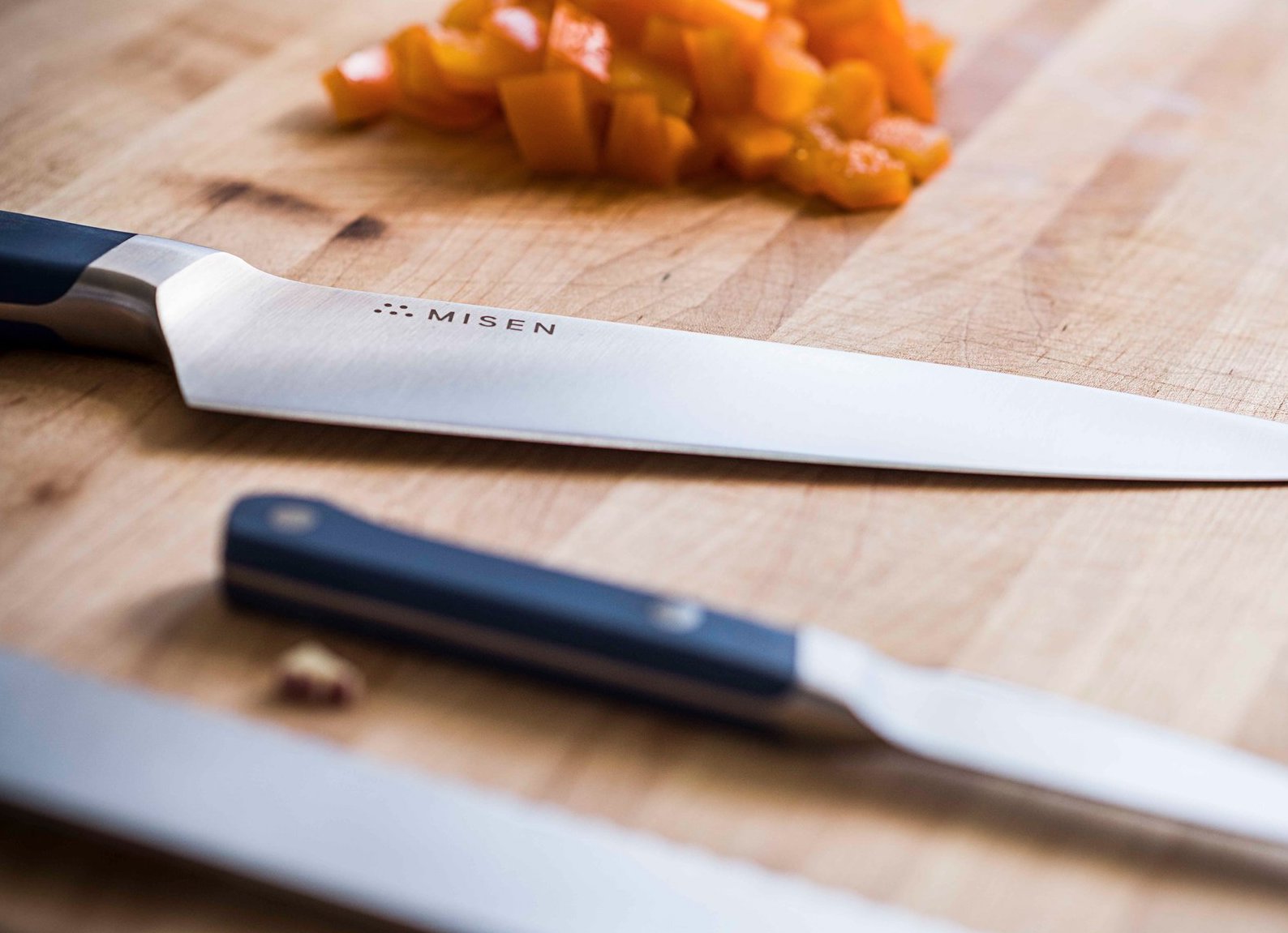 How to sharpen a knife: three Misen kitchen knives on a cutting board