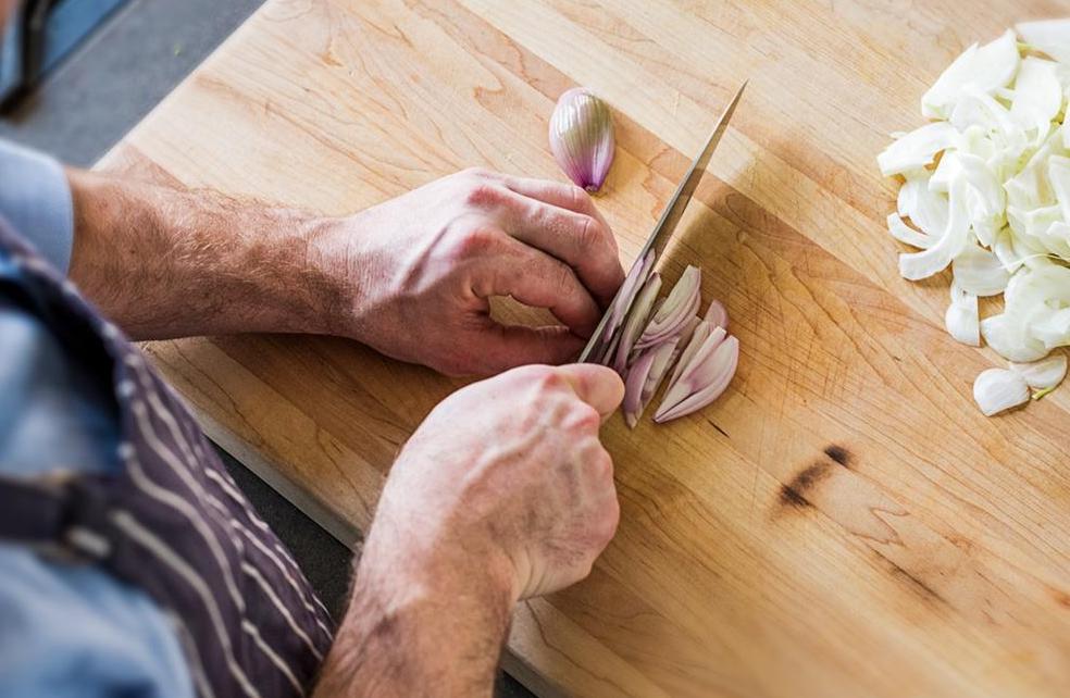 Knife shapes: A chef chops shallots