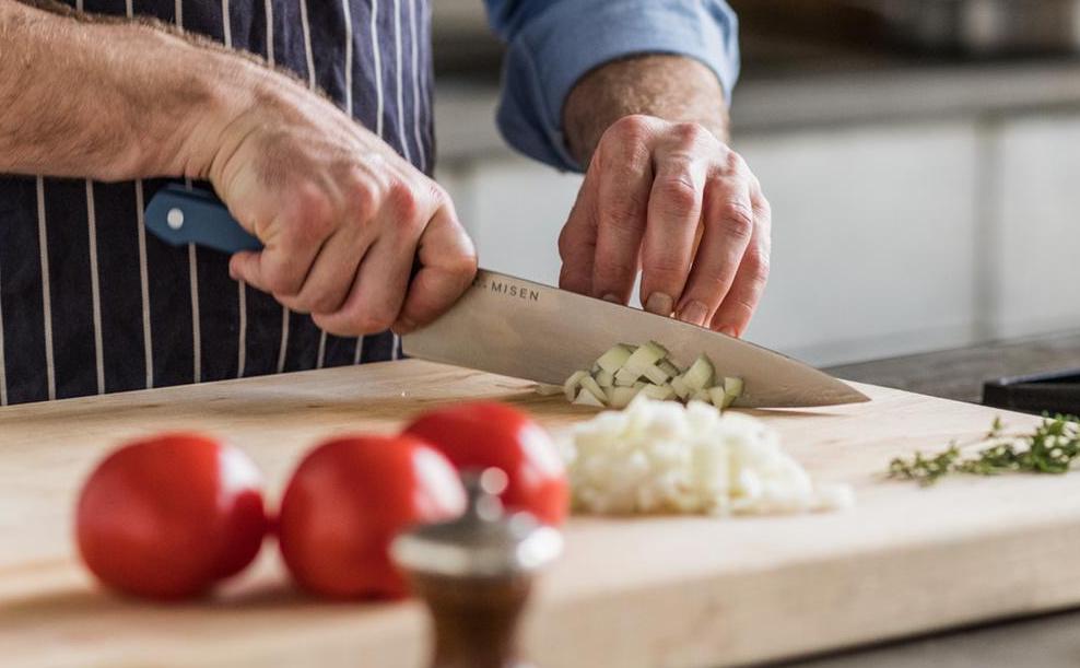 Best chef's knives: A chef chops onions with a Misen chef's knife