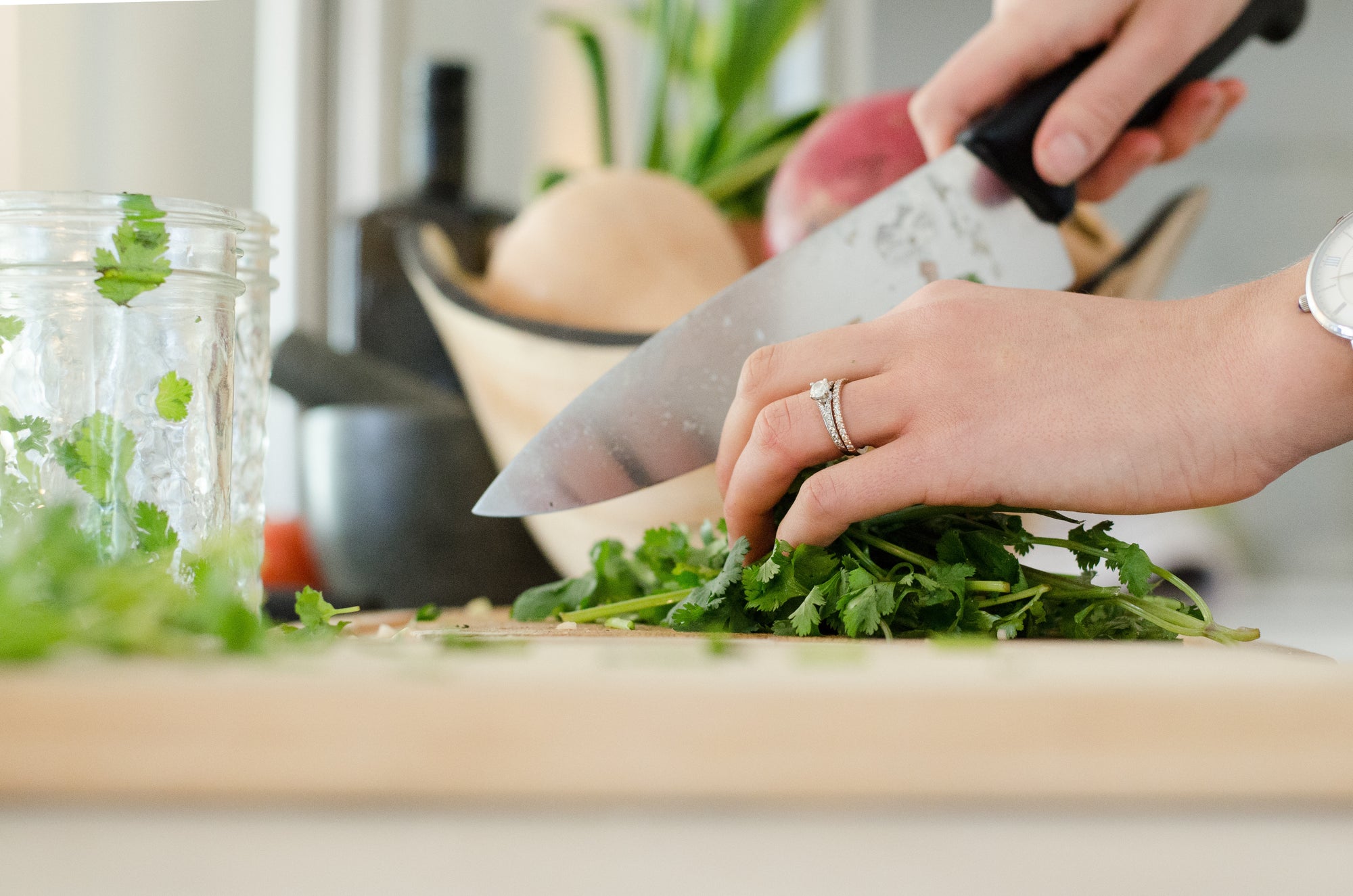 Chefs knives: A woman chops cilantro