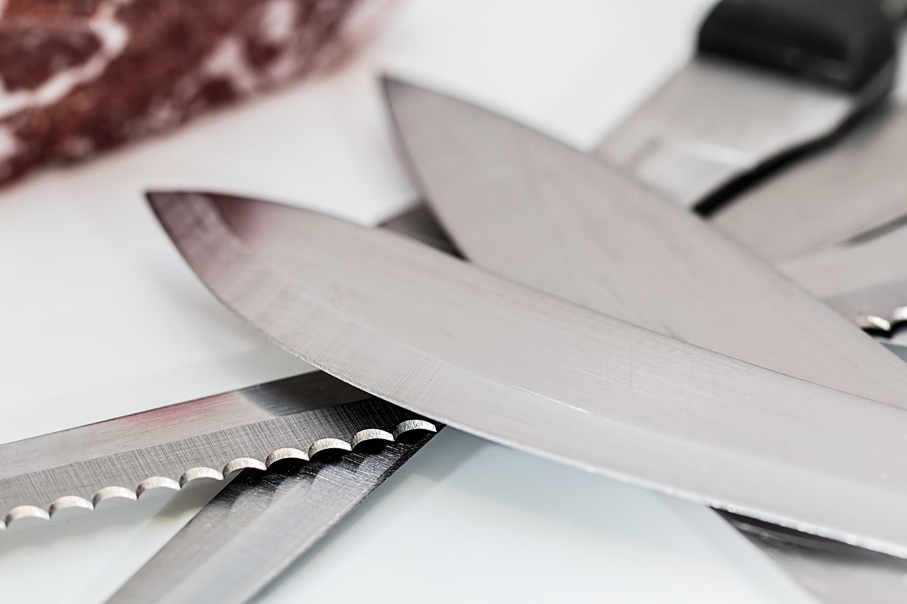 Serrated knife: kitchen knife blades in a pile