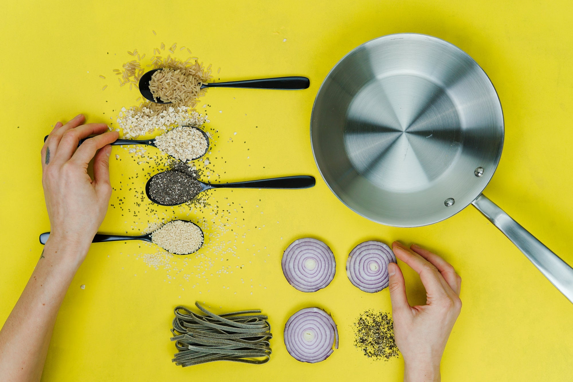 Cooking with stainless steel: artfully displayed ingredients around a stainless steel pan