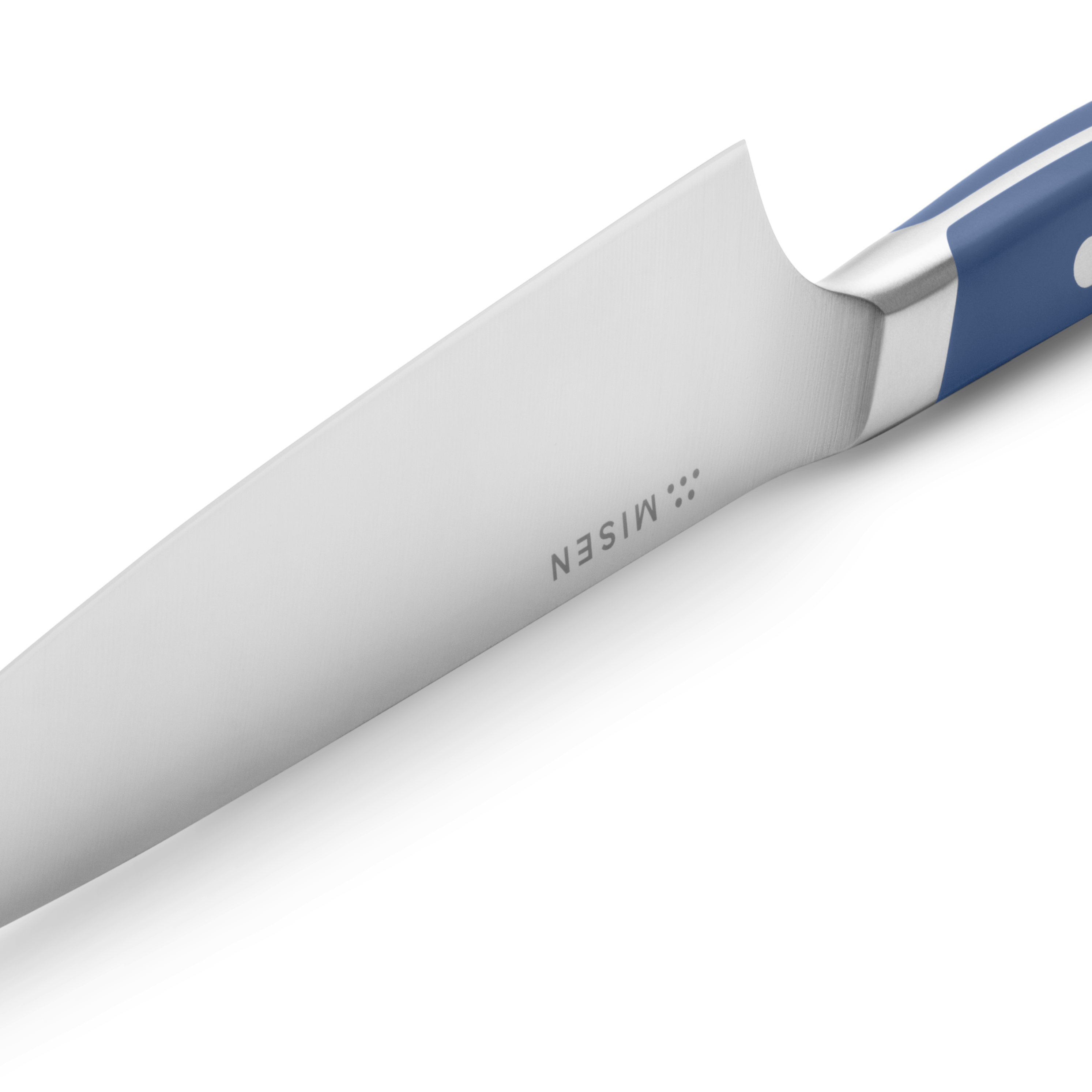 Misen knife blade close-up with blue handle and stainless steel bolster