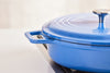 A close view of a blue Misen Enameled Cast Iron Braiser’s side wall, showing its chip-resistant enamel coating.