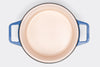 Blue Misen Dutch Oven without lid seen from above, showing light interior enamel on a white background.