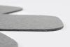 Close up of grey felt pan protector seen from the side on a white seamless background.