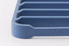 A close view of a blue Misen Silicone Roasting Rack, with perforated corners and the Misen logo showing.