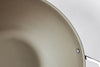 A close-up view of the Misen Carbon Steel Wok’s surface, on a white background.