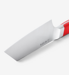 Misen knife blade close-up with red handle showing steel bolster