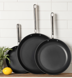 3-piece nonstick frying pan set with stainless steel handles displayed against white subway tile