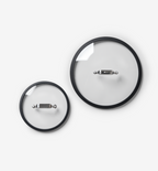 Two glass pot lids with black rim and stainless steel handle, small and large sizes