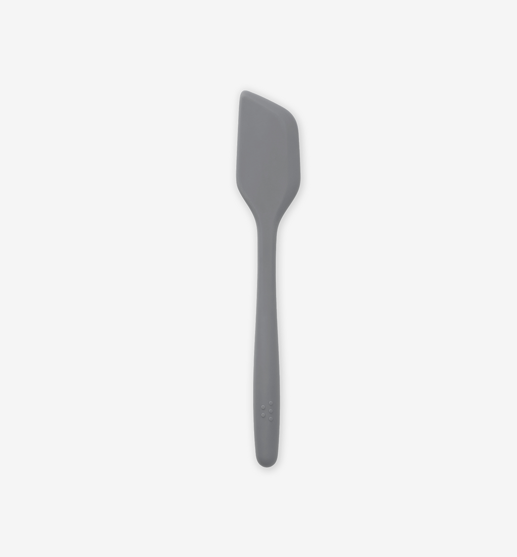 Gray silicone spatula with angled flat head and ergonomic handle