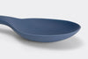 A close view of a Blue Misen Mixing Spoon’s curved head on a white background.