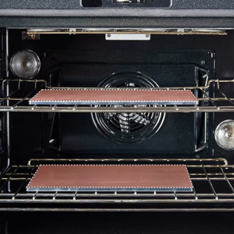 Baking stones on two oven racks inside convection oven