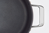 A bird’s eye view of the Misen 8 QT Nonstick Stockpot, with one handle and half of the base visible.