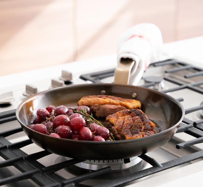 Pan roasted chicken with grapes and thyme in a Misen Pre-Seasoned Carbon Steel Pan.