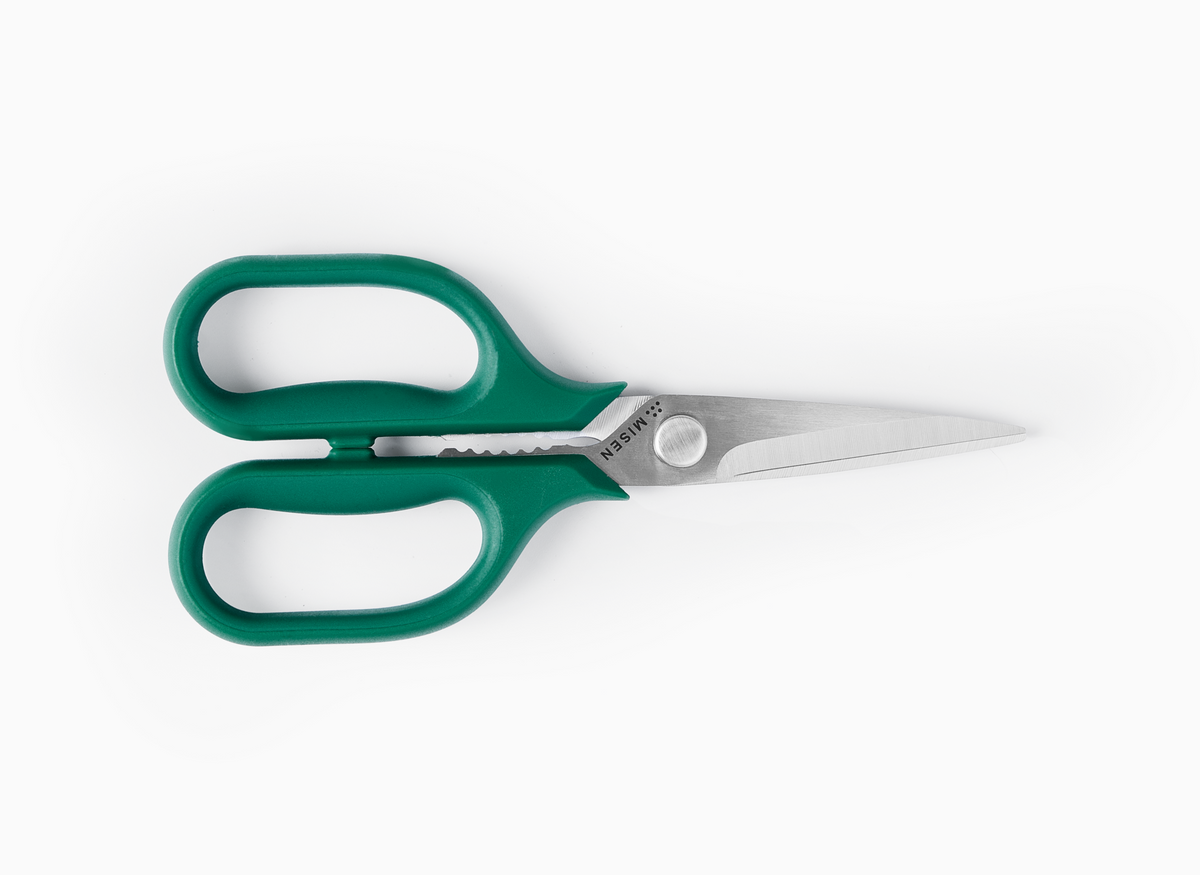 Pair of small Misen Kitchen Shears with green handles on a white background