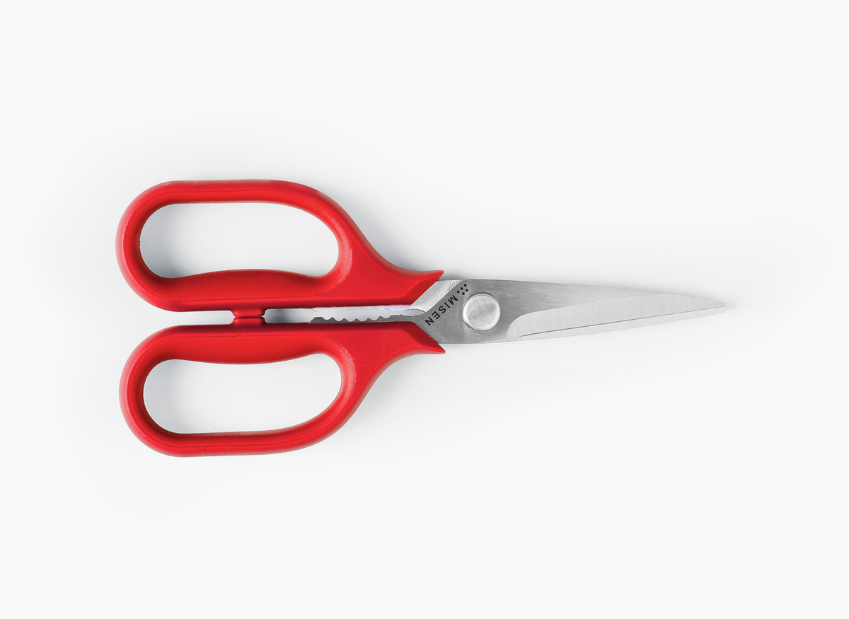 Pair of small Misen Kitchen Shears with red handles on a white background