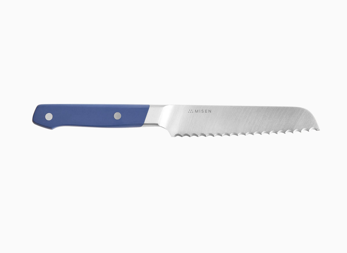 A side view of a blue Misen Short Serrated Knife on a white background.