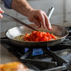 Sauteéing tomatoes and onions in a Misen Stainless Steel Skillet