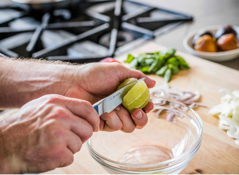 Paring a lime with a blue Misen Paring Knife