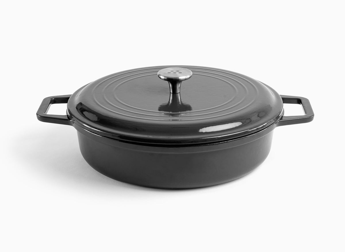 A black Misen Enameled Cast Iron Braiser with knob-handle lid. Misen logo is visible on the lid’s central handle.