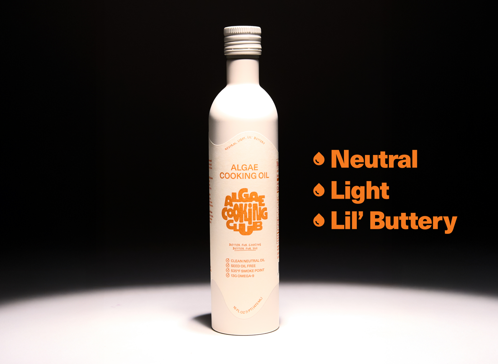 A single white bottle of Algae Cooking Oil with a white cap is depicted against a black background with a spotlight effect. The bottle's label, in orange text, reads "ALGAE COOKING OIL" above the "ALGAE COOKING CLUB" logo. Below the logo, features are listed, including "CLEAN NEUTRAL OIL," "SEED OIL FREE," and "535°F SMOKE POINT." To the right, three large orange bullet points emphasize the oil's qualities: "Neutral," "Light," and "Lil' Buttery."