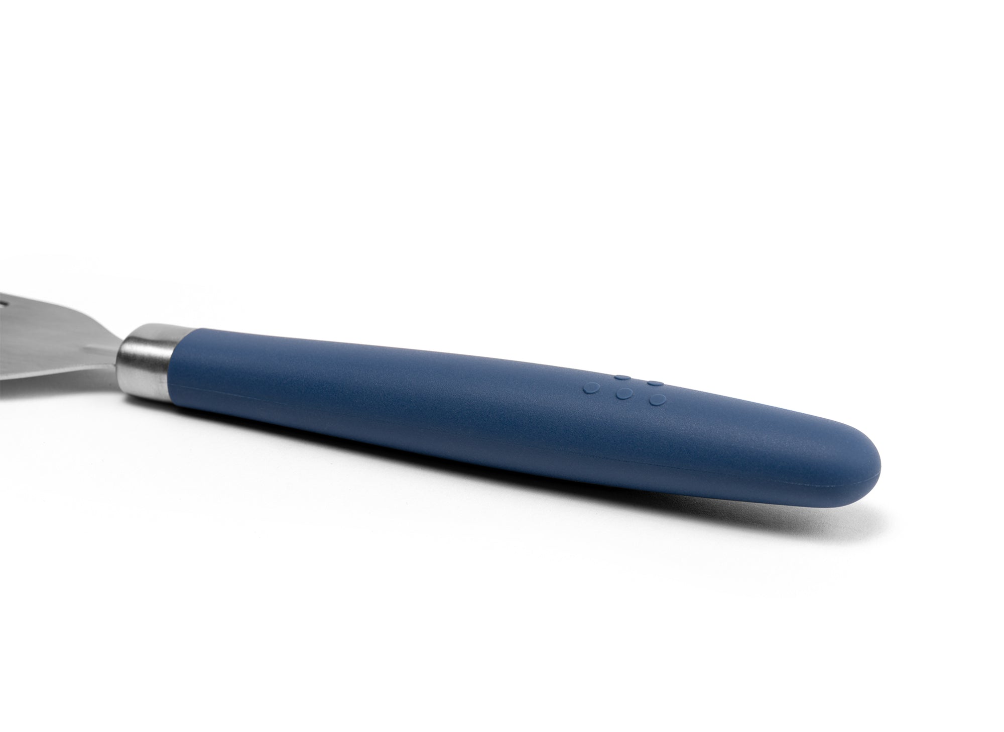 A close view of the Blue Misen Metal Fish Spatula’s slotted head. It’s long, slightly flared, and made of bare steel.