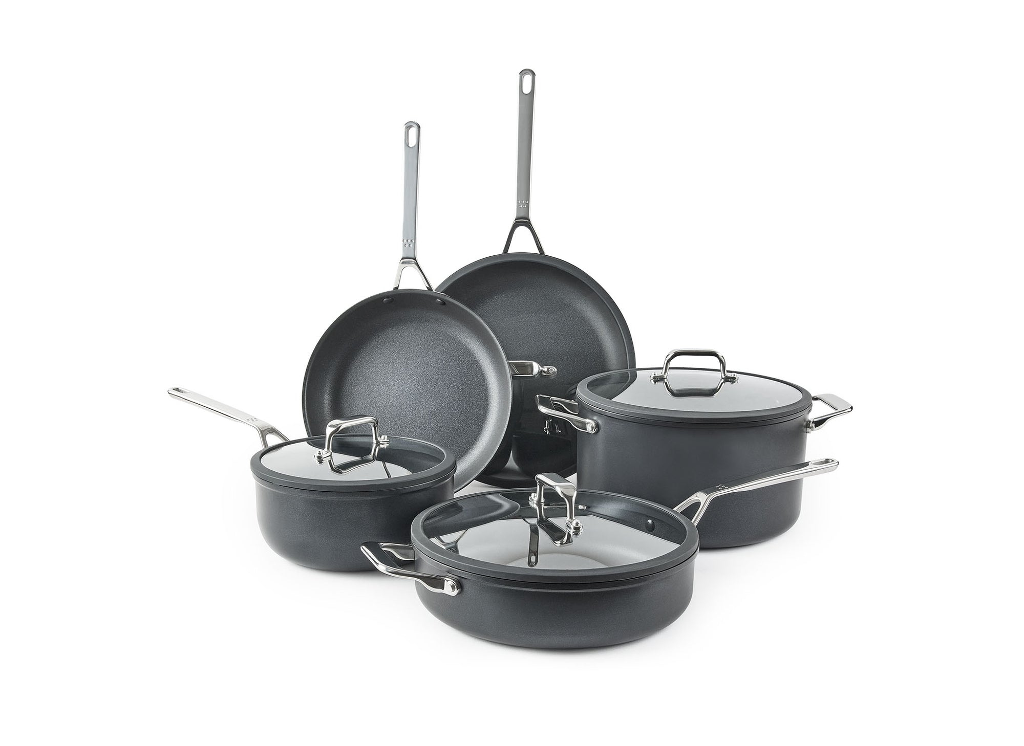The Misen 9-Piece Essentials Cookware Set on a white background, with most pieces visible: the 10- and 12-inch Nonstick Pans, Nonstick Stock Pot, Nonstick Sauté, and Nonstick Saucier, with lids.