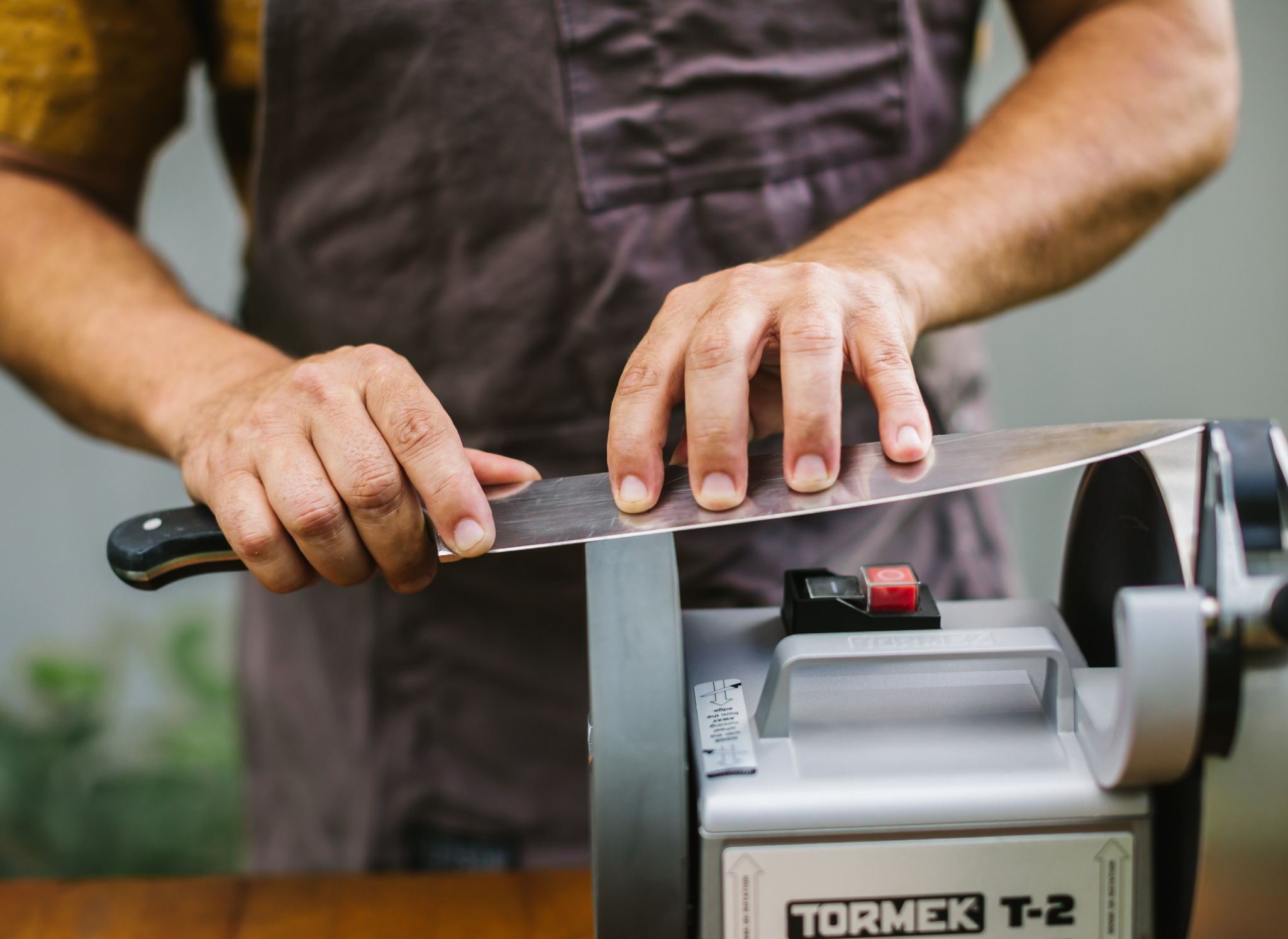 Sharpening a black Misen Chef's Knife on a diamond wheel