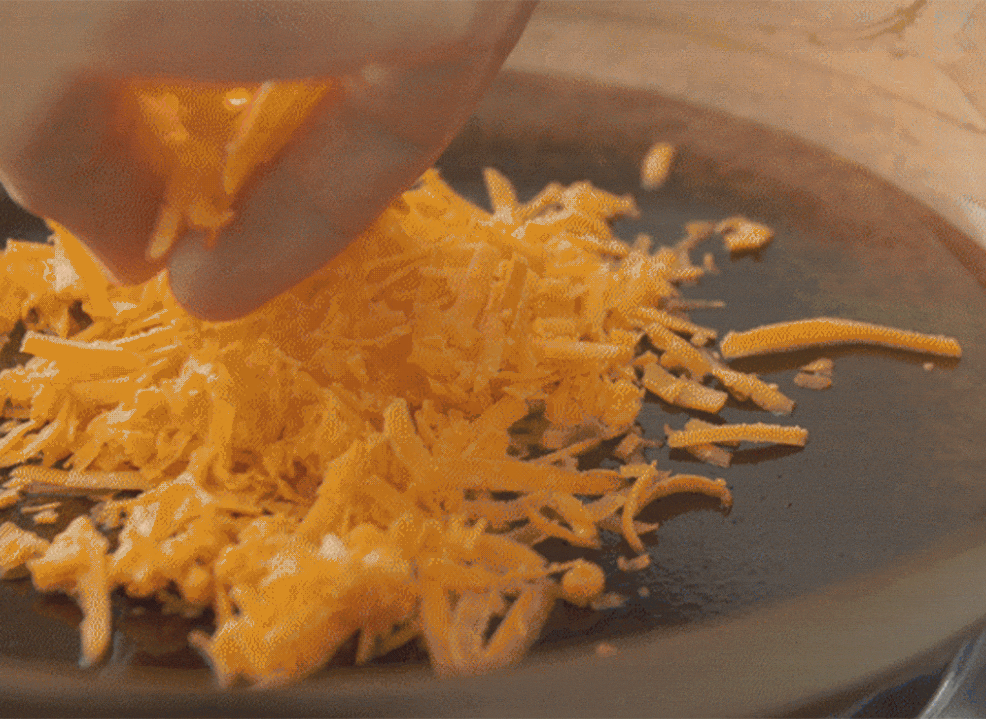 Frying shredded cheese in a Misen Pre-seasoned Carbon Steel Pan without it burning or getting stuck to the bottom.