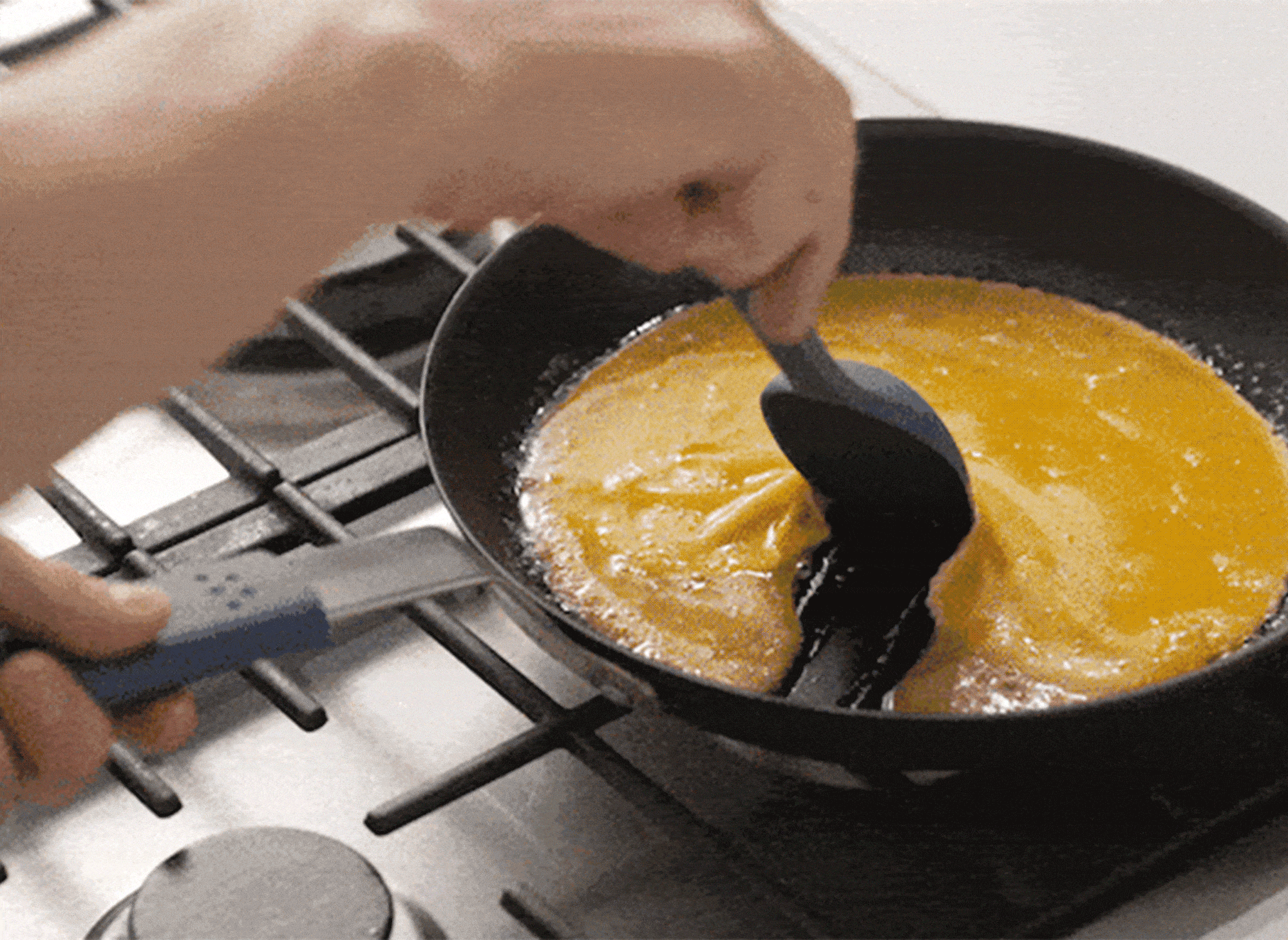 A gif that shows an egg swirling around in a Misen Pre-Seasoned Carbon Steel Pan, two salmon filets being shook in a Misen Pre-Seasoned Carbon Steel Pan, and scrambled eggs not getting stuck to the bottom of a Misen Pre-Seasoned Carbon Steel Pan.