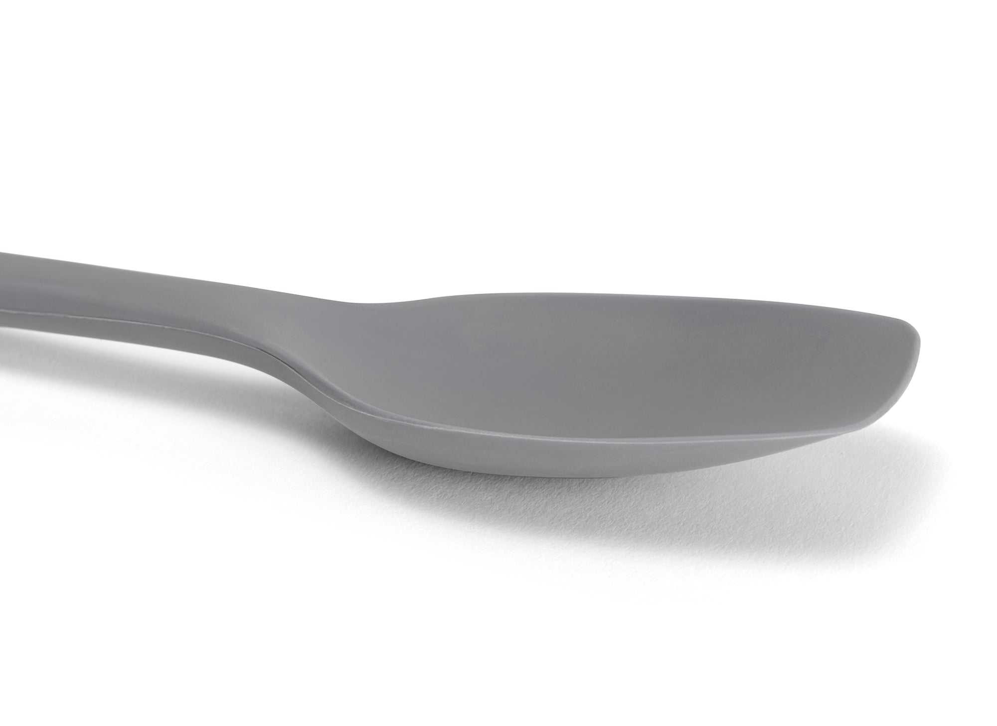 Close view of a Grey Misen Spoontula’s silicone head, deeply curved like a spoon with a spatula’s flexible rounded corners.
