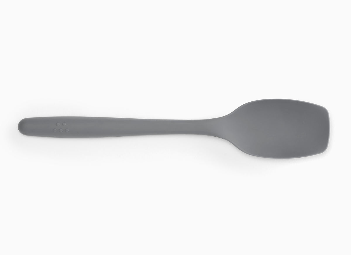 Gray Misen Spoontula seen from above on a white background. A curved spoon-like head with rounded corner edges and a long handle.