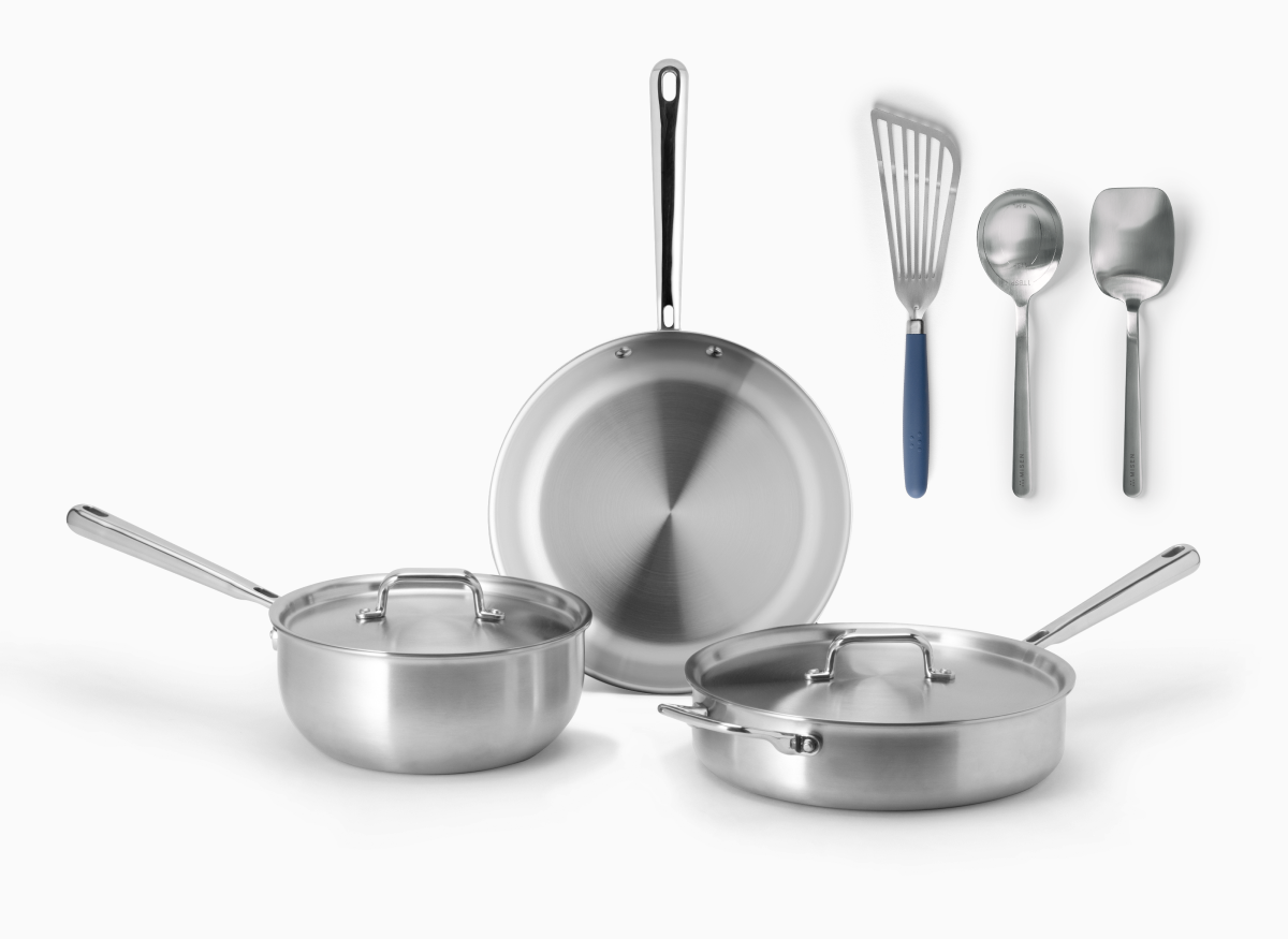 The image depicts a five-piece set of Misen stainless steel cookware and three Misen cooking tools against a white background.

The cookware includes:

  * A 10 inch frying pan with a long handle.
  * A saucier and sauté with lids and side handles.

The cooking tools shown are:

  * A slotted stainless steel fish spatula with a blue handle.
  * A measuring chef spoon.
  * A scraper chef spoon.