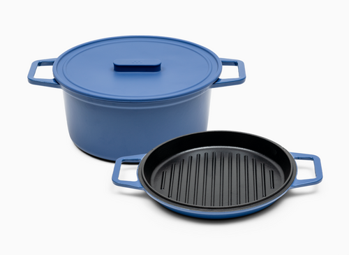 A blue Dutch oven with a silicone lid and a detachable lid that has a grill pan.