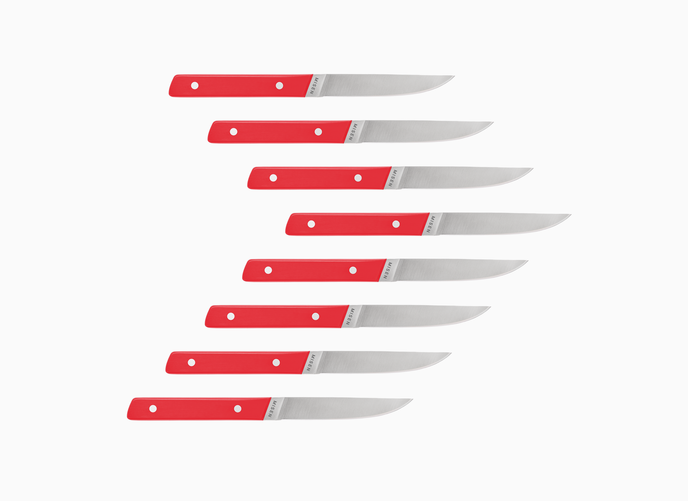 Set of eight straight edge Misen ACUTO steak knives with red handles on a white background