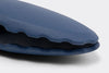 Close up view of the silicone-covered scalloped head on a set of blue Misen Tongs, seen on a white background.