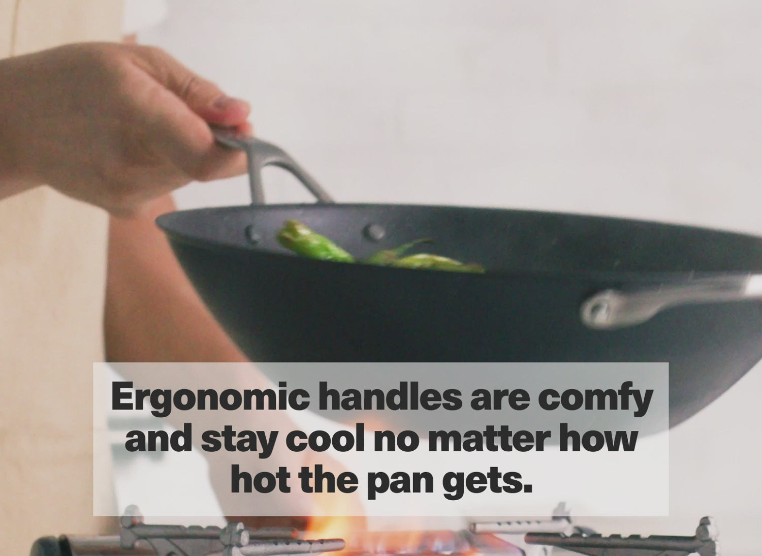 The Misen Wok's ergonomic handles are comfy and stay cool no matter how hot the pan gets.