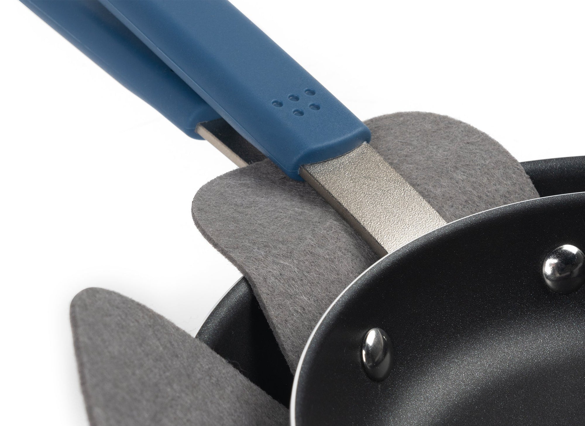 {{1-pack,2-pack}} Close up of stacked nonstick pan handles, with a grey felt pan protector between the upper and lower pans.