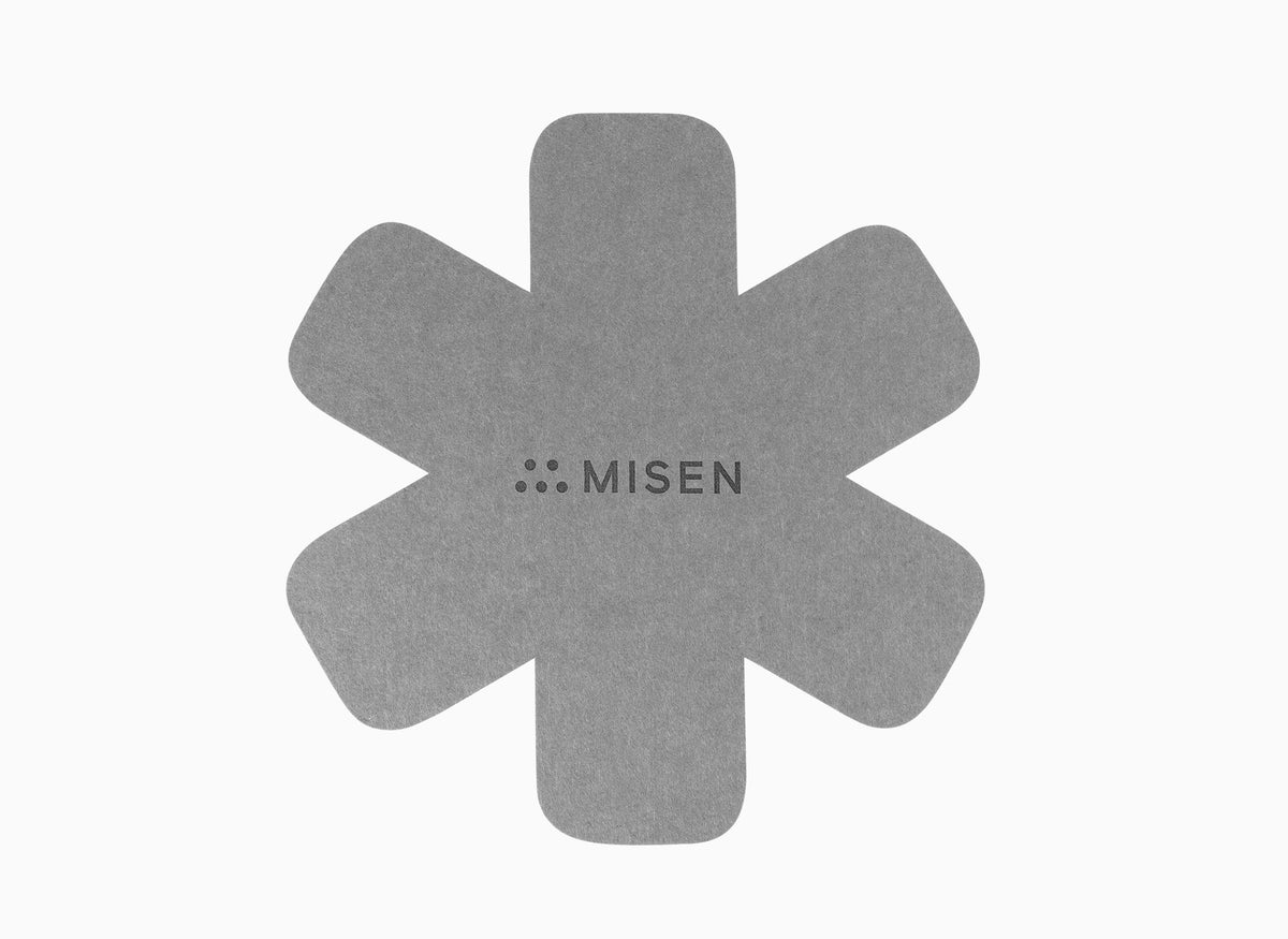 Star-shaped grey felt pan protector with Misen logo on a white seamless background.