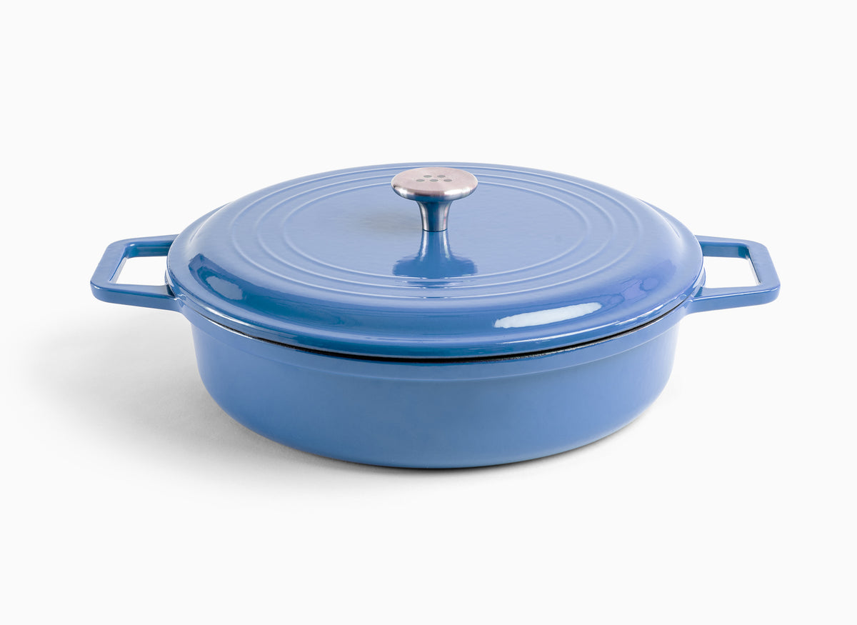A blue Misen Enameled Cast Iron Braiser with knob-handle lid. Misen logo is visible on the lid’s central handle.